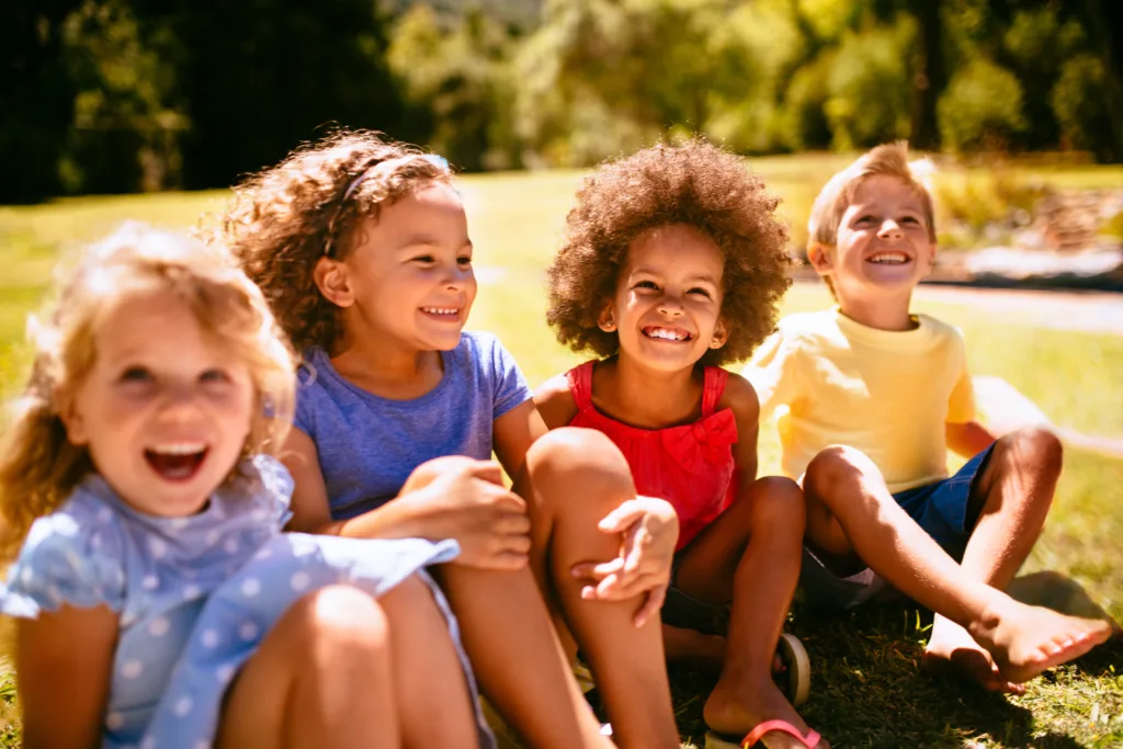 Mixed racial group of friendly children laughing together